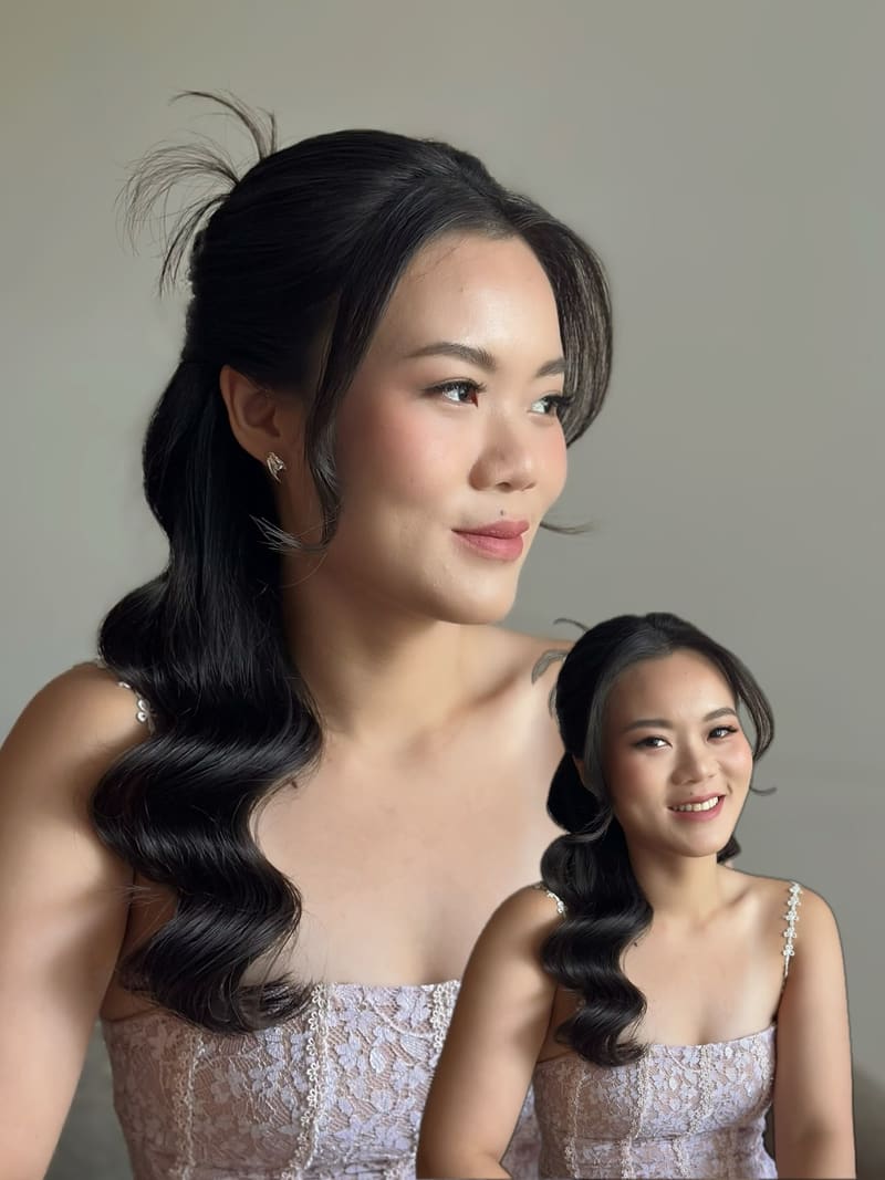 Two women in lilac dresses with matching half-up side waves